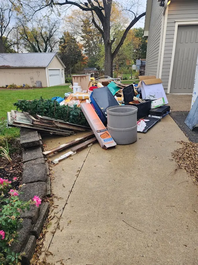 Dumpster being loaded with debris for 12 Yard Dumpster Rental in Marietta
